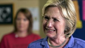 Democratic presidential candidate Hillary Clinton reacts as she listens to a question from the audience during a campaign event at Uncle Nancy's Coffee in Newton, Iowa